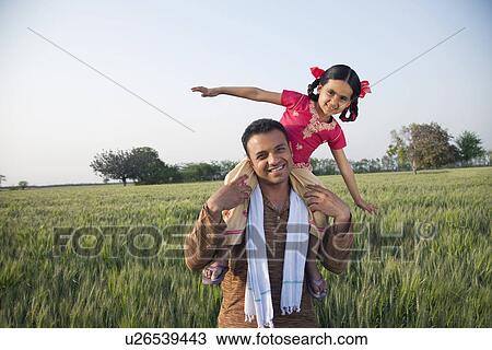 Portrait of a carefree daughter on father's shoulders View Large Photo Image Stock Image - Portrait of a carefree daughter on father's shoulders . Fotosearch