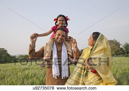 Portrait of a cheerful rural family in the field View Large Photo Image Stock Photo - Portrait of a cheerful rural family in the field . Fotosearch