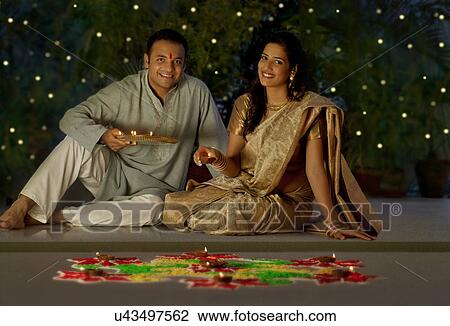 Stock Image - Portrait of a couple with diyas . Fotosearch