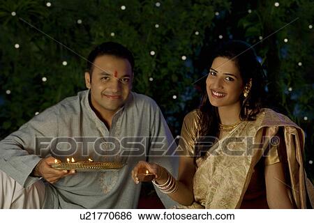 Portrait of a couple with diyas View Large Photo Image Stock Photograph - Portrait of a couple with diyas . Fotosearch