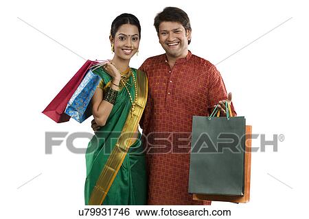 Stock Photograph - Portrait of a couple with shopping bags . Fotosearch