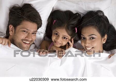 Portrait of a family in bed View Large Photo Image Stock Photo - Portrait of a family in bed . Fotosearch