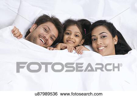 Portrait of a family in bed View Large Photo Image Stock Photograph - Portrait of a family in bed . Fotosearch
