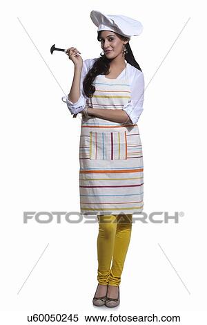 Stock Photography - Portrait of a female chef with a utensil. Fotosearch