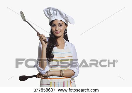Stock Photo - Portrait of a female chef with cooking utensils. Fotosearch