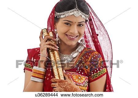 Picture - Portrait of a female dandiya dancer with sticks . Fotosearch