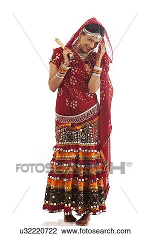 Portrait of a female dandiya dancer with sticks View Large Photo Image Stock Image - Portrait of a female dandiya dancer with sticks . Fotosearch