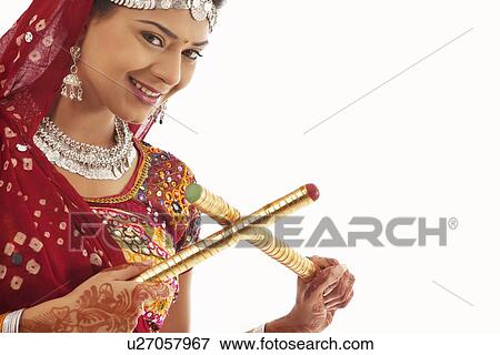 Portrait of a female dandiya dancer with sticks View Large Photo Image Stock Photo - Portrait of a female dandiya dancer with sticks . Fotosearch