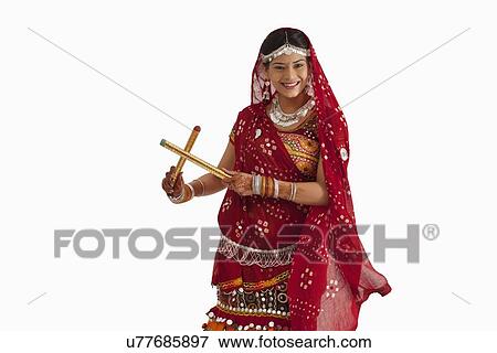 Stock Photo - Portrait of a female dandiya dancer with sticks . Fotosearch