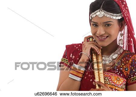 Portrait of a female dandiya dancer with sticks View Large Photo Image Stock Photograph - Portrait of a female dandiya dancer with sticks . Fotosearch