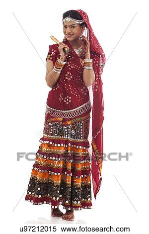 Stock Photography - Portrait of a female dandiya dancer with sticks . Fotosearch