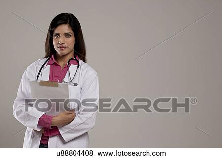 Stock Photo - Portrait of a female doctor with a clip board . Fotosearch