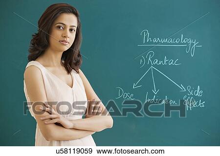 Portrait of a female professor with arms crossed standing against blue board View Large Photo Image Stock Photo - Portrait of a female professor with arms crossed standing against blue board . Fotosearch