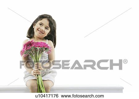 Portrait of a girl holding flowers View Large Photo Image Stock Photograph - Portrait of a girl holding flowers . Fotosearch