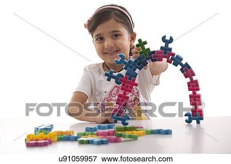 Stock Photo - Portrait of a girl with building blocks . Fotosearch