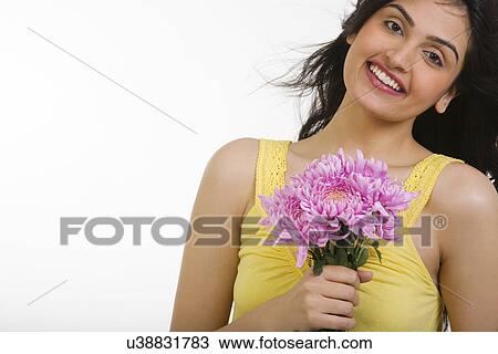Stock Image - Portrait of a girl with flowers . Fotosearch