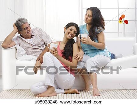 Stock Photo - Portrait of a girl with her parents . Fotosearch