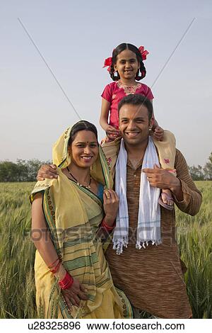 Stock Photograph - Portrait of a happy Indian family in the field . Fotosearch