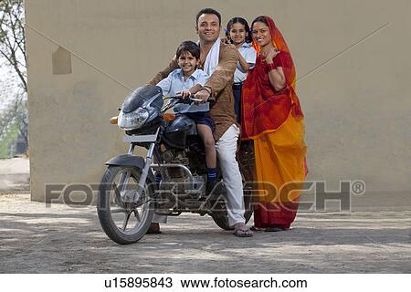 Portrait of a happy Indian family on bike View Large Photo Image Stock Image - Portrait of a happy Indian family on bike . Fotosearch