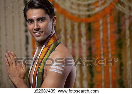 Stock Photo - Portrait of a Hindu groom with hands clasped on his wedding day . Fotosearch