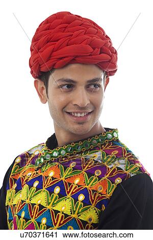 Stock Image - Portrait of a male dandiya dancer . Fotosearch