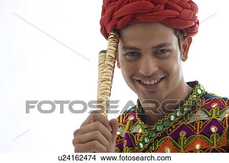 Portrait of a male dandiya dancer with sticks View Large Photo Image Picture - Portrait of a male dandiya dancer with sticks . Fotosearch