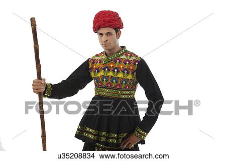 Portrait of a male dandiya dancer with a stick View Large Photo Image Picture - Portrait of a male dandiya dancer with a stick . Fotosearch