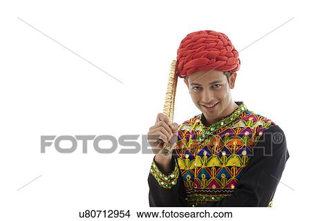 Portrait of a male dandiya dancer with sticks View Large Photo Image Picture - Portrait of a male dandiya dancer with sticks . Fotosearch