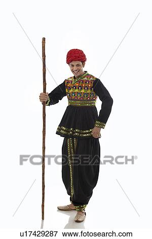 Stock Photo - Portrait of a male dandiya dancer with a stick . Fotosearch