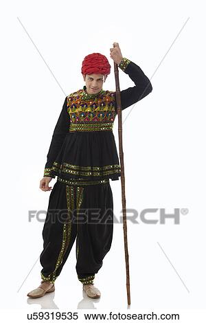 Stock Photography - Portrait of a male dandiya dancer with a stick . Fotosearch