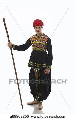 Portrait of a male dandiya dancer with a stick View Large Photo Image Stock Photography - Portrait of a male dandiya dancer with a stick . Fotosearch