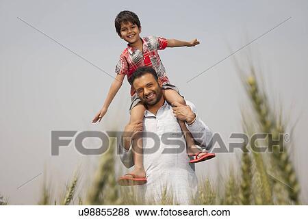 Stock Photo - Portrait of a man carrying little boy on shoulders . Fotosearch