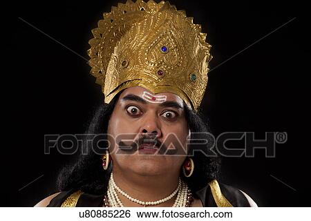 Stock Photograph - Portrait of a man dressed as Raavan . Fotosearch