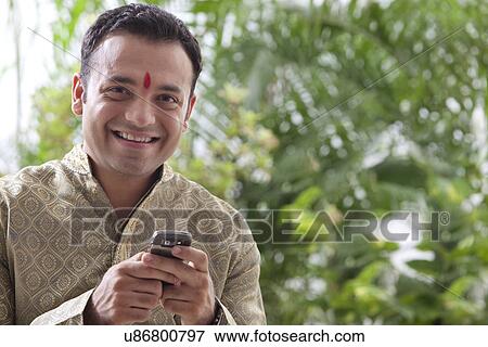 Portrait of a man with a mobile phone View Large Photo Image Stock Photo - Portrait of a man with a mobile phone . Fotosearch