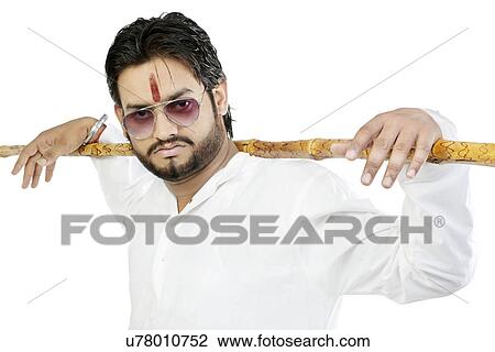 Stock Image - Portrait of a man with a stick . Fotosearch