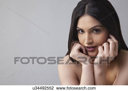 Portrait of a pretty young female with long hair over colored background View Large Photo Image Stock Image - Portrait of a pretty young female with long hair over colored background . Fotosearch