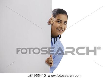 Portrait of a school girl peeping out View Large Photo Image Stock Image - Portrait of a school girl peeping out . Fotosearch