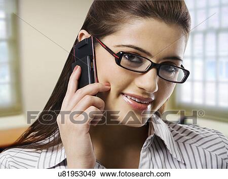 Portrait of a secretary talking on a mobile phone View Large Photo Image Stock Photo - Portrait of a secretary talking on a mobile phone . Fotosearch