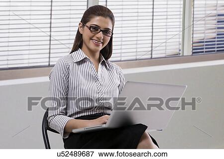 Portrait of a secretary with a laptop View Large Photo Image Stock Photo - Portrait of a secretary with a laptop . Fotosearch