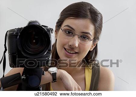 Portrait of a smiling young woman with digital camera View Large Photo Image Stock Image - Portrait of a smiling young woman with digital camera . Fotosearch