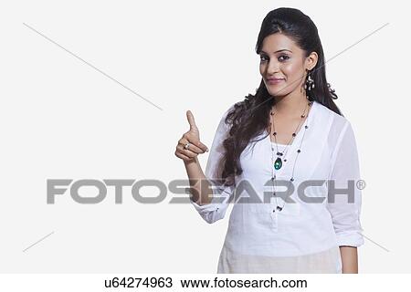 Stock Image - Portrait of a woman giving thumbs up sign. Fotosearch