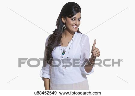 Portrait of a woman giving thumbs up sign View Large Photo Image Stock Photo - Portrait of a woman giving thumbs up sign. Fotosearch