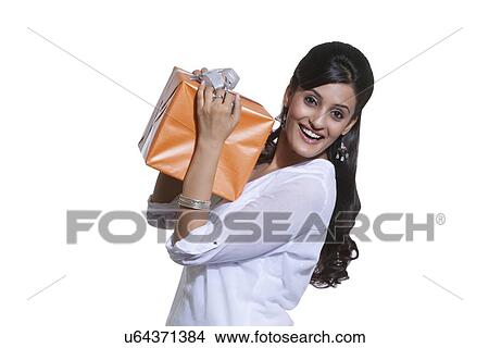 Portrait of a woman holding a gift box View Large Photo Image Picture - Portrait of a woman holding a gift box. Fotosearch