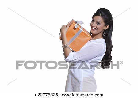 Portrait of a woman holding a gift box View Large Photo Image Stock Photography - Portrait of a woman holding a gift box. Fotosearch