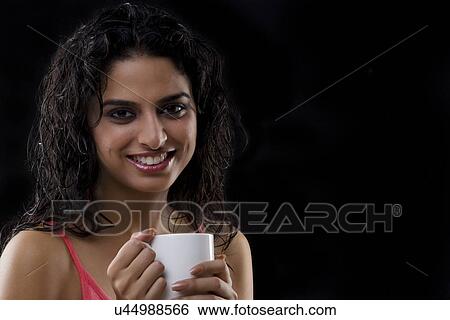 Stock Photograph - Portrait of a woman holding a mug . Fotosearch