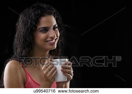Portrait of a woman holding a mug View Large Photo Image Stock Photograph - Portrait of a woman holding a mug . Fotosearch