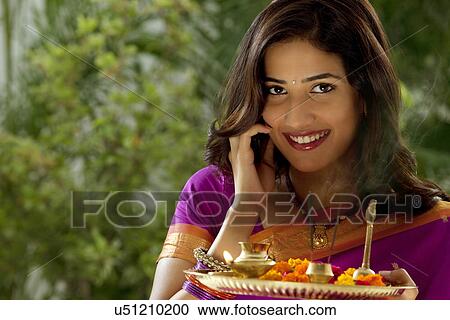Portrait of a woman holding a tray View Large Photo Image Stock Image - Portrait of a woman holding a tray . Fotosearch