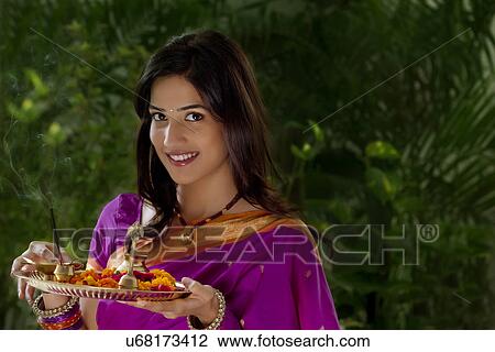 Portrait of a woman holding a tray View Large Photo Image Stock Image - Portrait of a woman holding a tray . Fotosearch