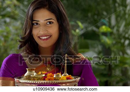 Stock Photograph - Portrait of a woman holding a tray . Fotosearch