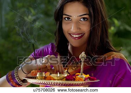 Portrait of a woman holding a tray View Large Photo Image Stock Photograph - Portrait of a woman holding a tray . Fotosearch